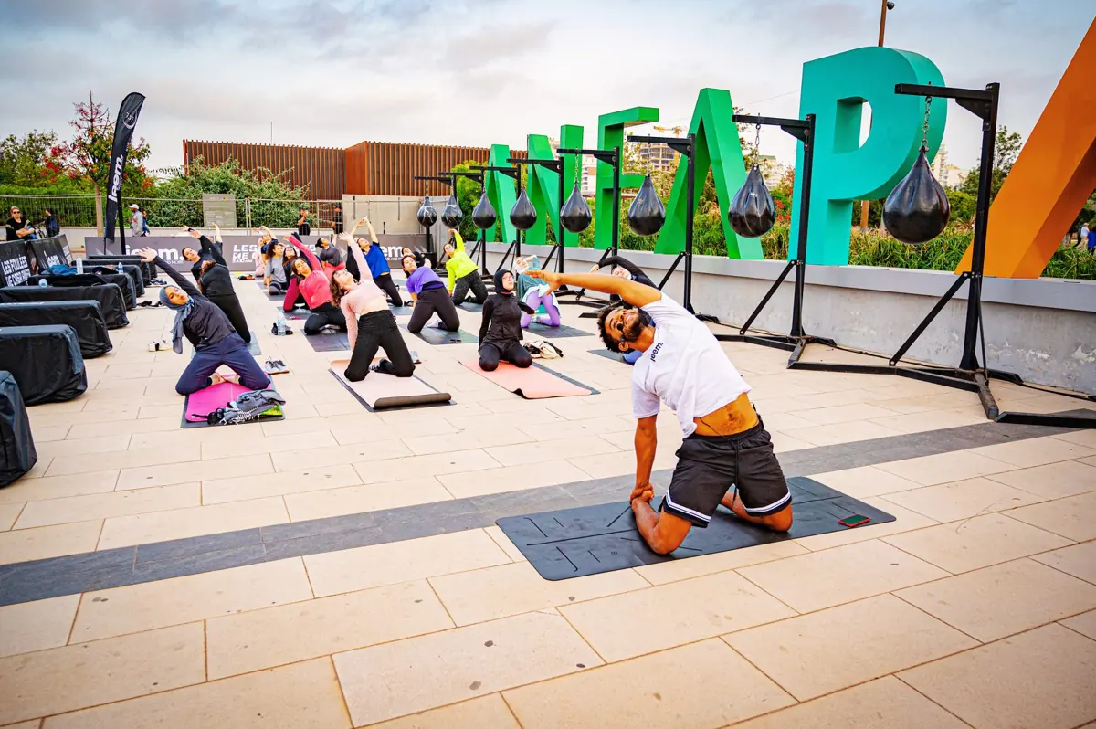 Outdoor yoga class in front of the Anfapark letters
