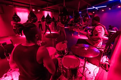 A live band playing during a boxing class at jeem