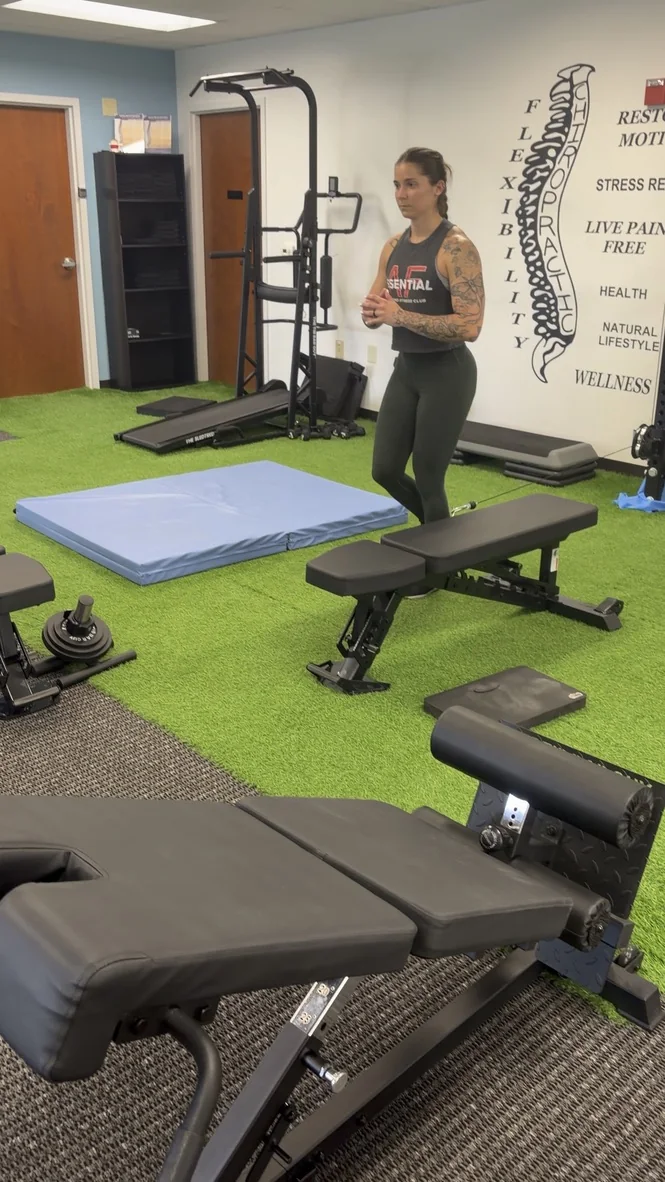Dr. Austin Pollack assessing an athlete's movement and mobility at For Health Chiropractic
