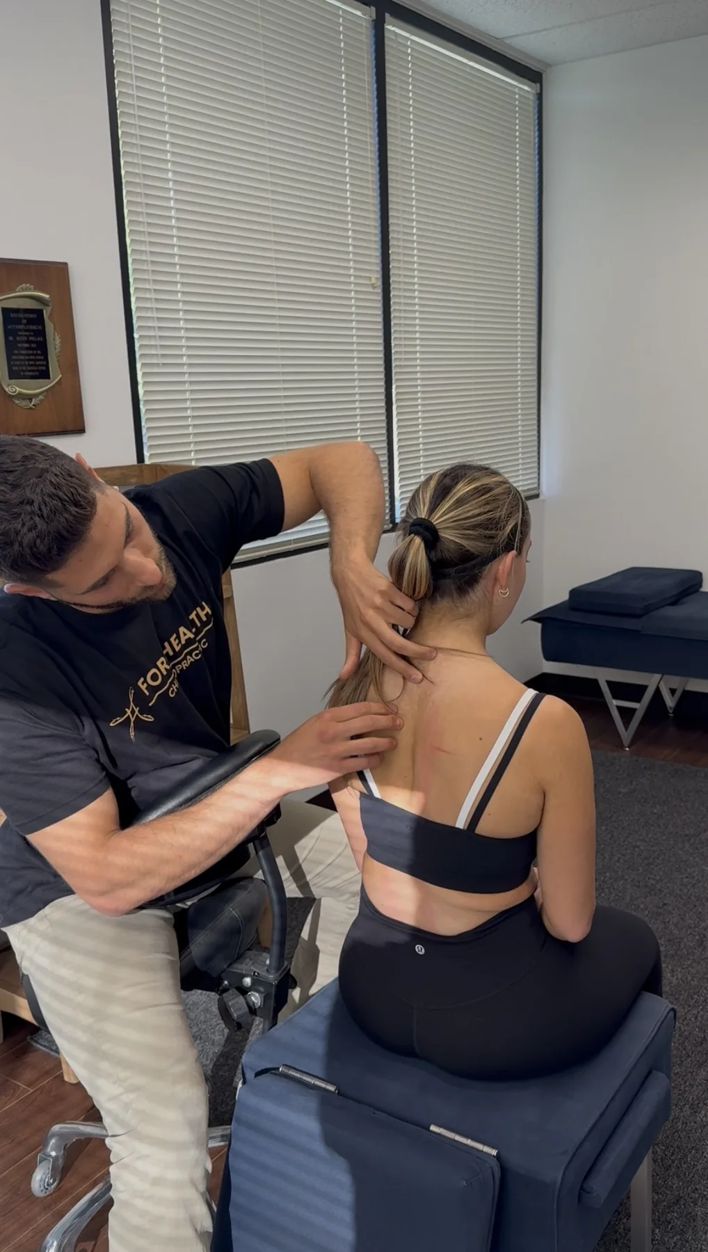 Dr. Austin Pollack performing a Gonstead chiropractic assessment in Warminster, PA