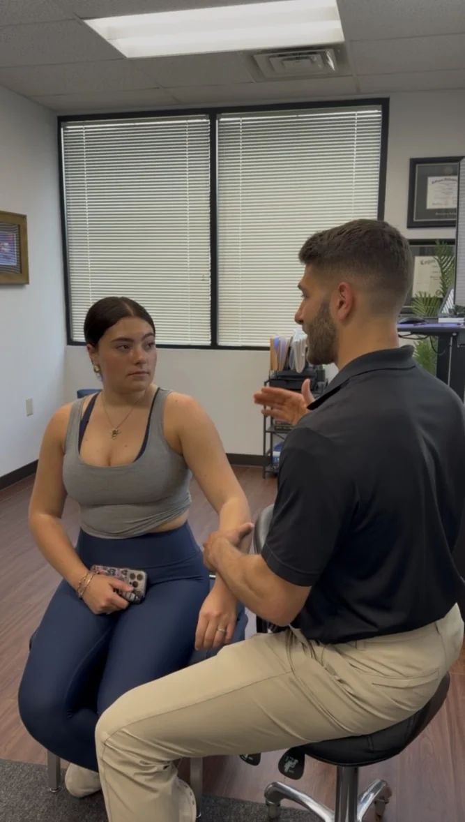 Dr. Austin Pollack consulting with a patient at For Health Chiropractic in Warminster, PA