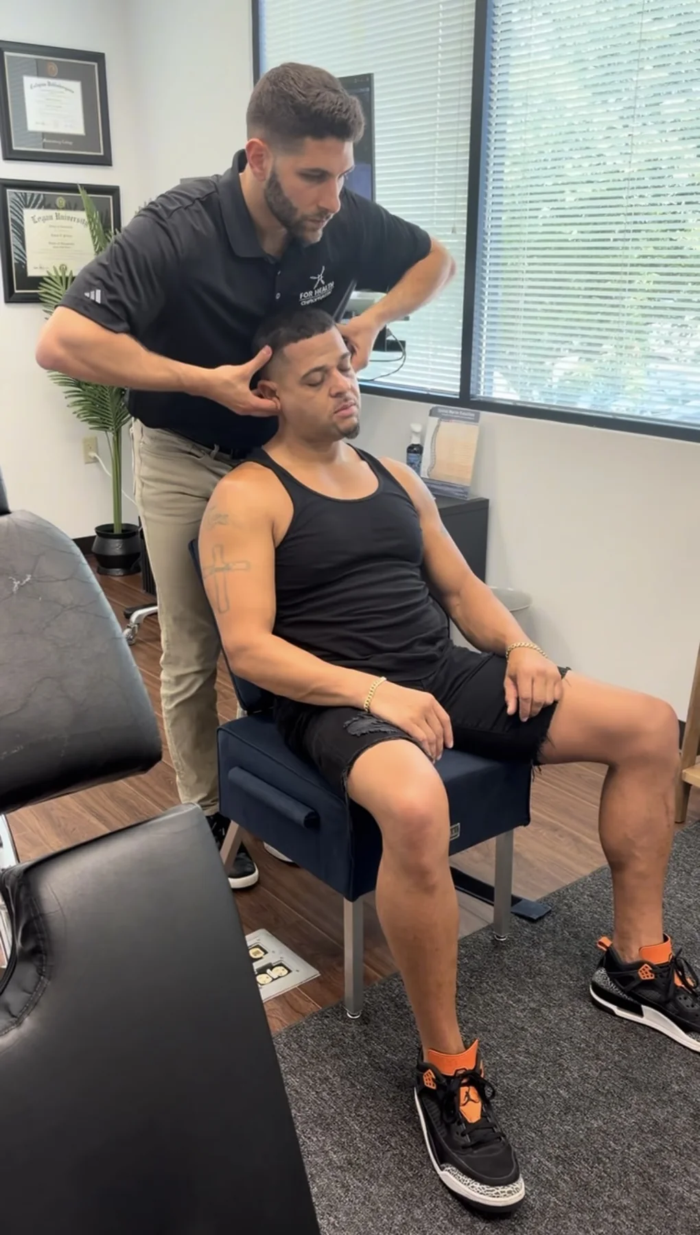 Dr. Austin Pollack consulting with a patient at For Health Chiropractic