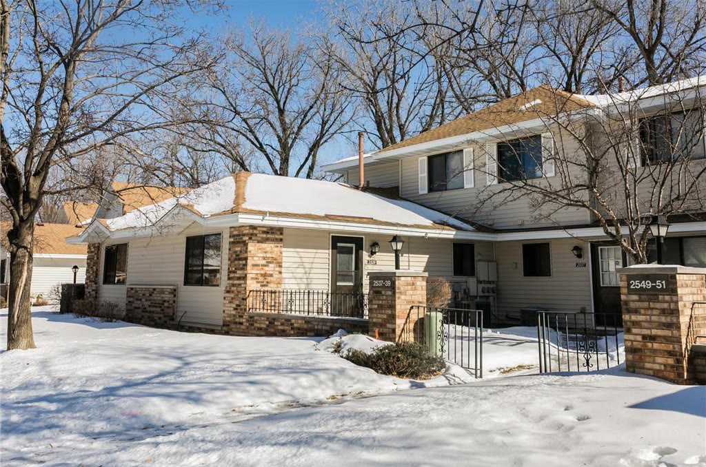 Brick and siding townhome investment property in fresh snow.