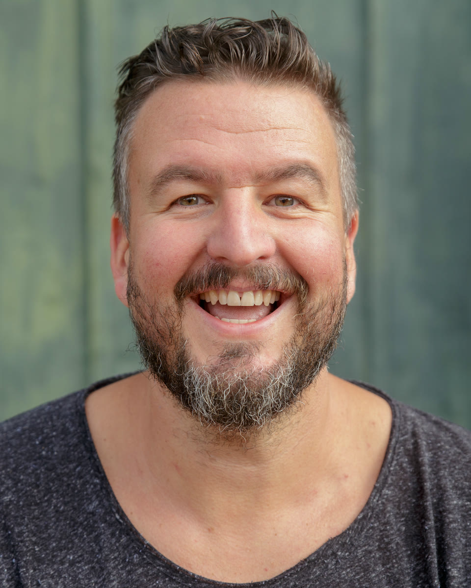 Sebastian Watzinger, smiling, in a dark t-shirt.