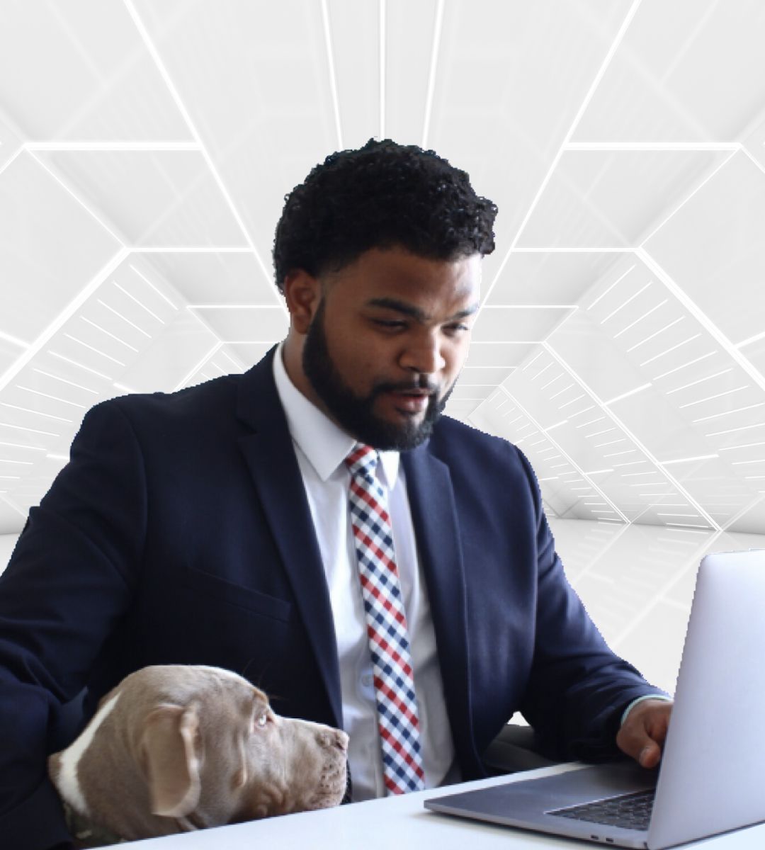 Chris Mateo in a suit using a laptop