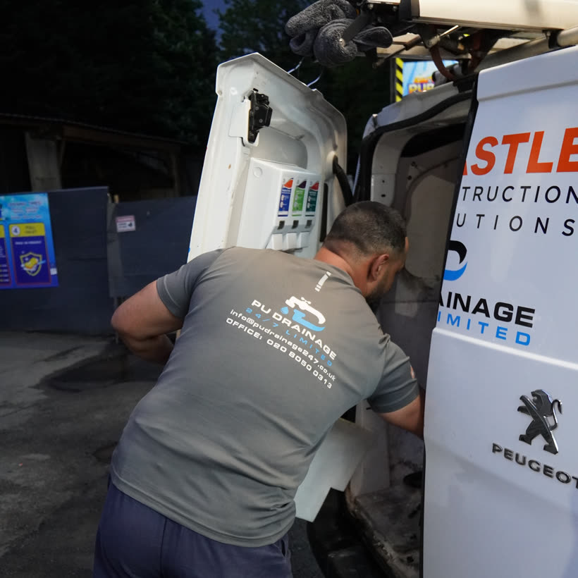 PU Drainage engineer loading the branded van between jobs