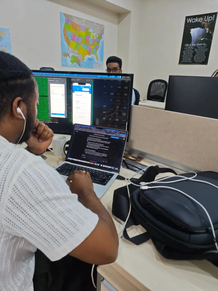 QIS engineer at a workstation with a U.S. map on the wall