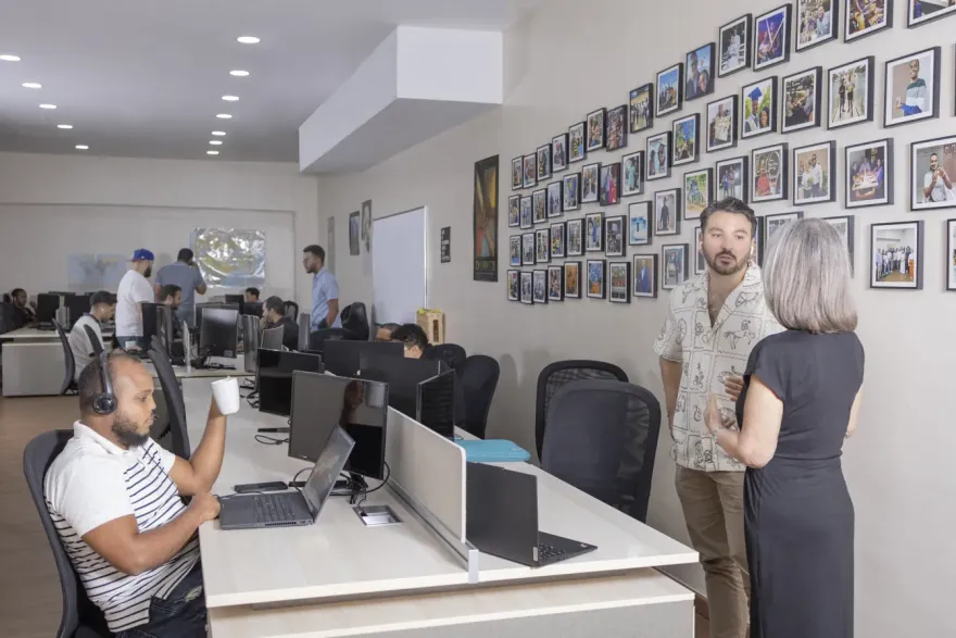 QIS office interior with a wall of team photos