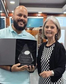 Dagoberto receiving a five-year recognition award at QIS