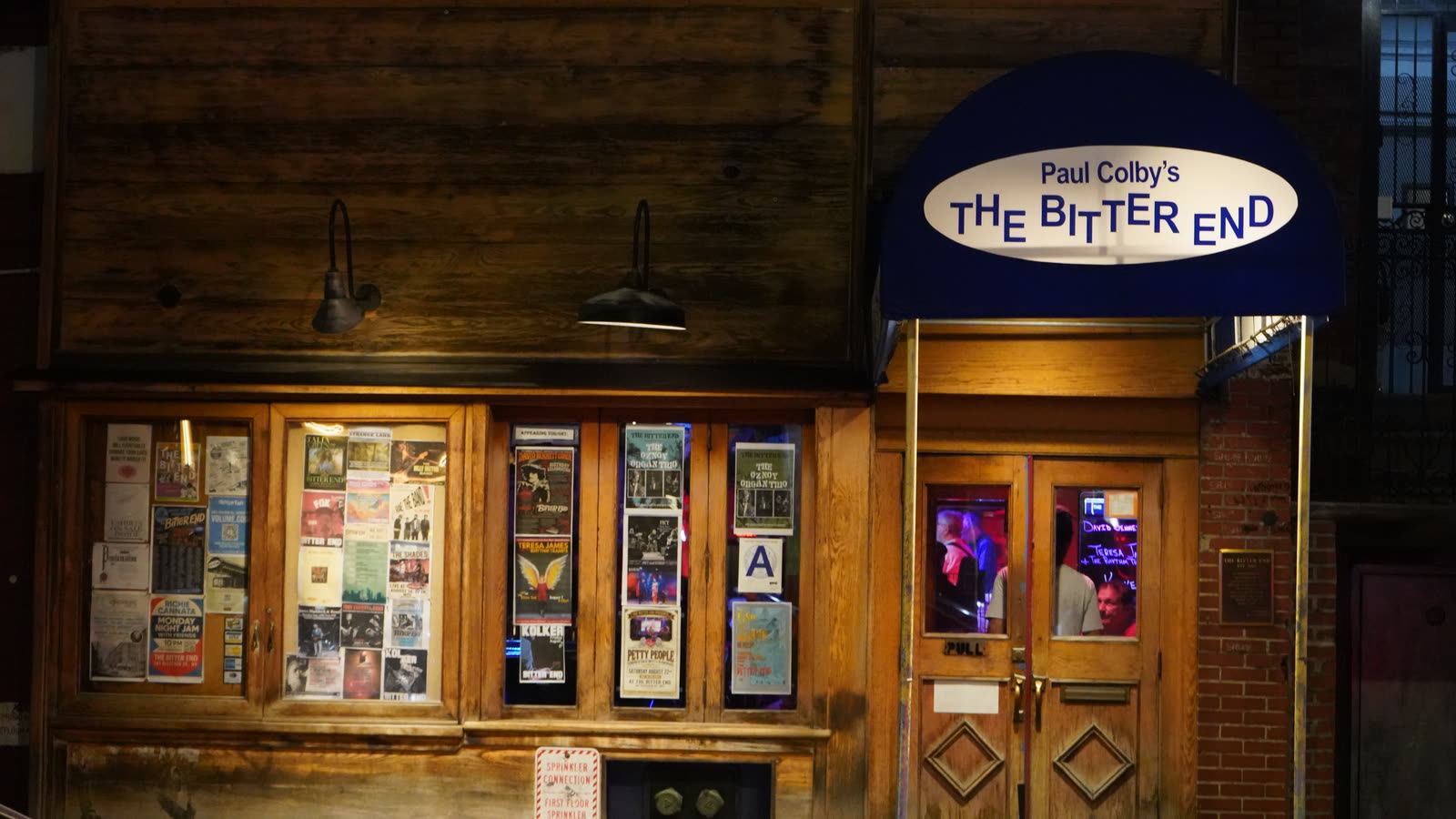 The Bitter End storefront at 147 Bleecker Street, with a Kolker poster in the window