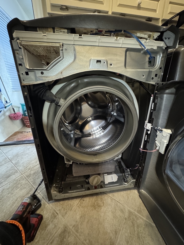 Maytag Maxima washer with the front panel removed for drain pump diagnosis in Fairfield, California