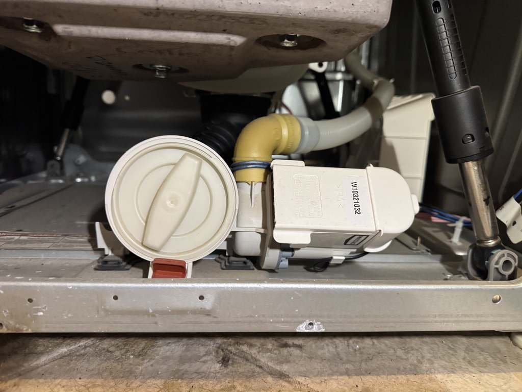 Maytag front-load washer drain pump and filter assembly inspected during repair