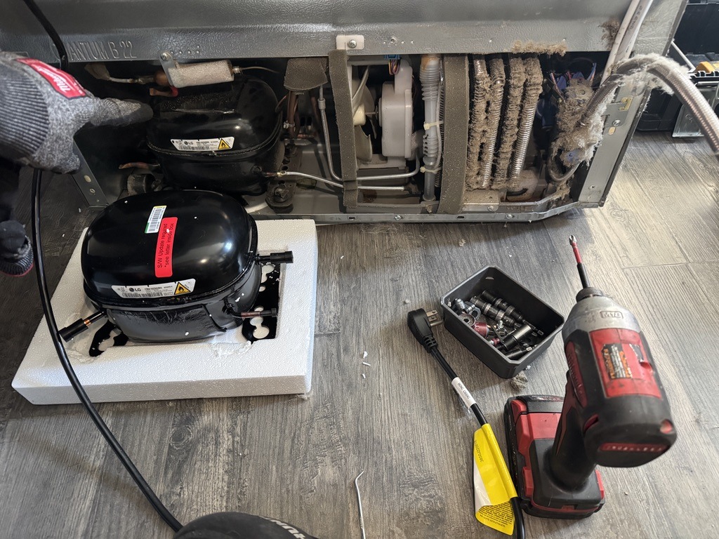 Old and replacement LG refrigerator compressors during sealed-system repair