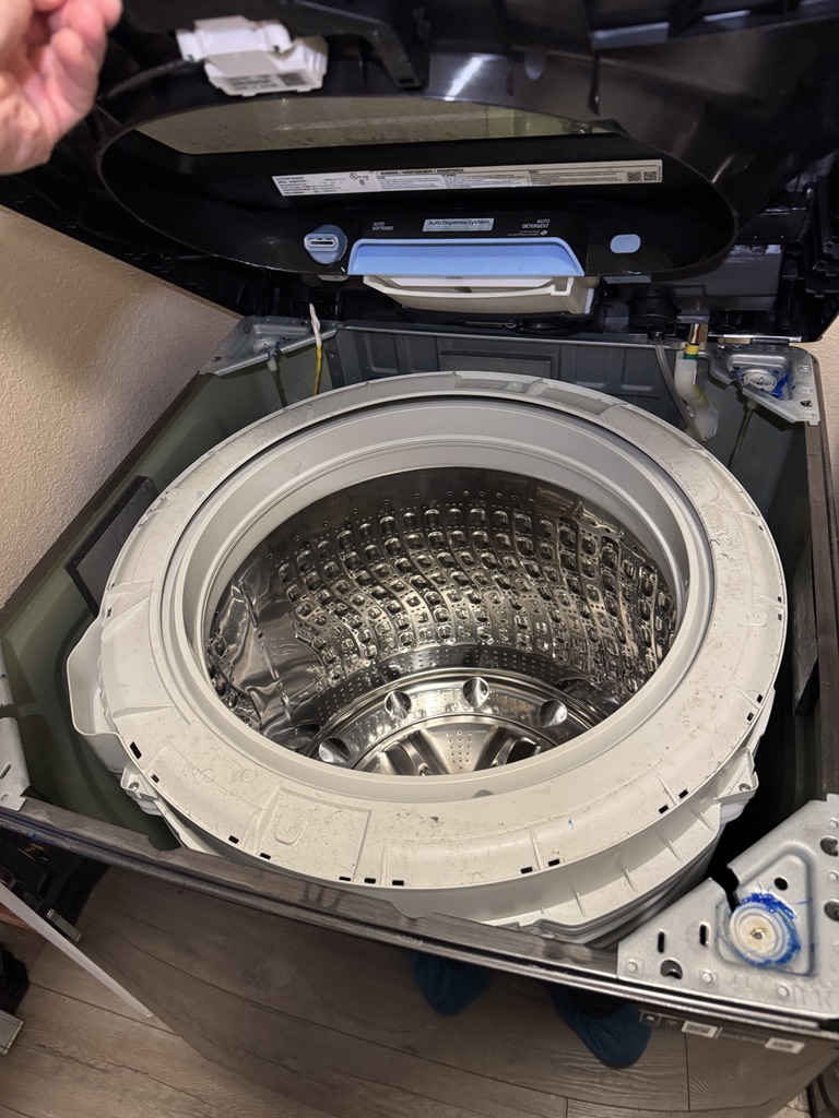 Samsung top-load washer opened to access the tub suspension during a Fairfield-area repair