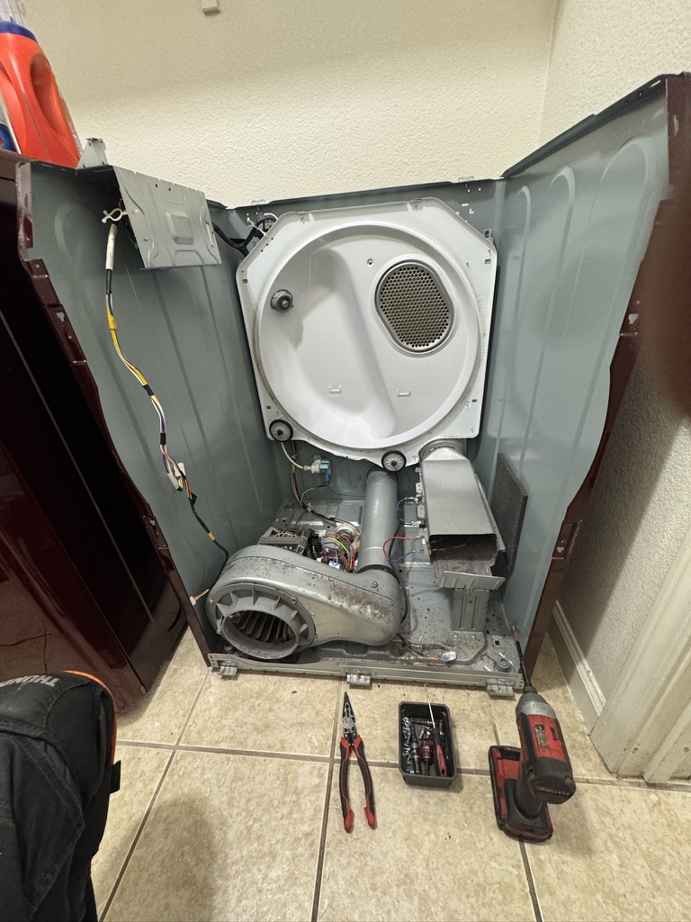 Samsung electric dryer opened for heating element replacement with lint visible inside the cabinet in Fairfield