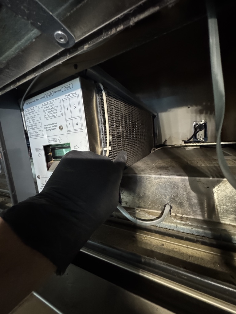 Sub-Zero PRO 48 condenser coil accessed for maintenance Sub-Zero PRO 48 condenser coil accessed for maintenance
