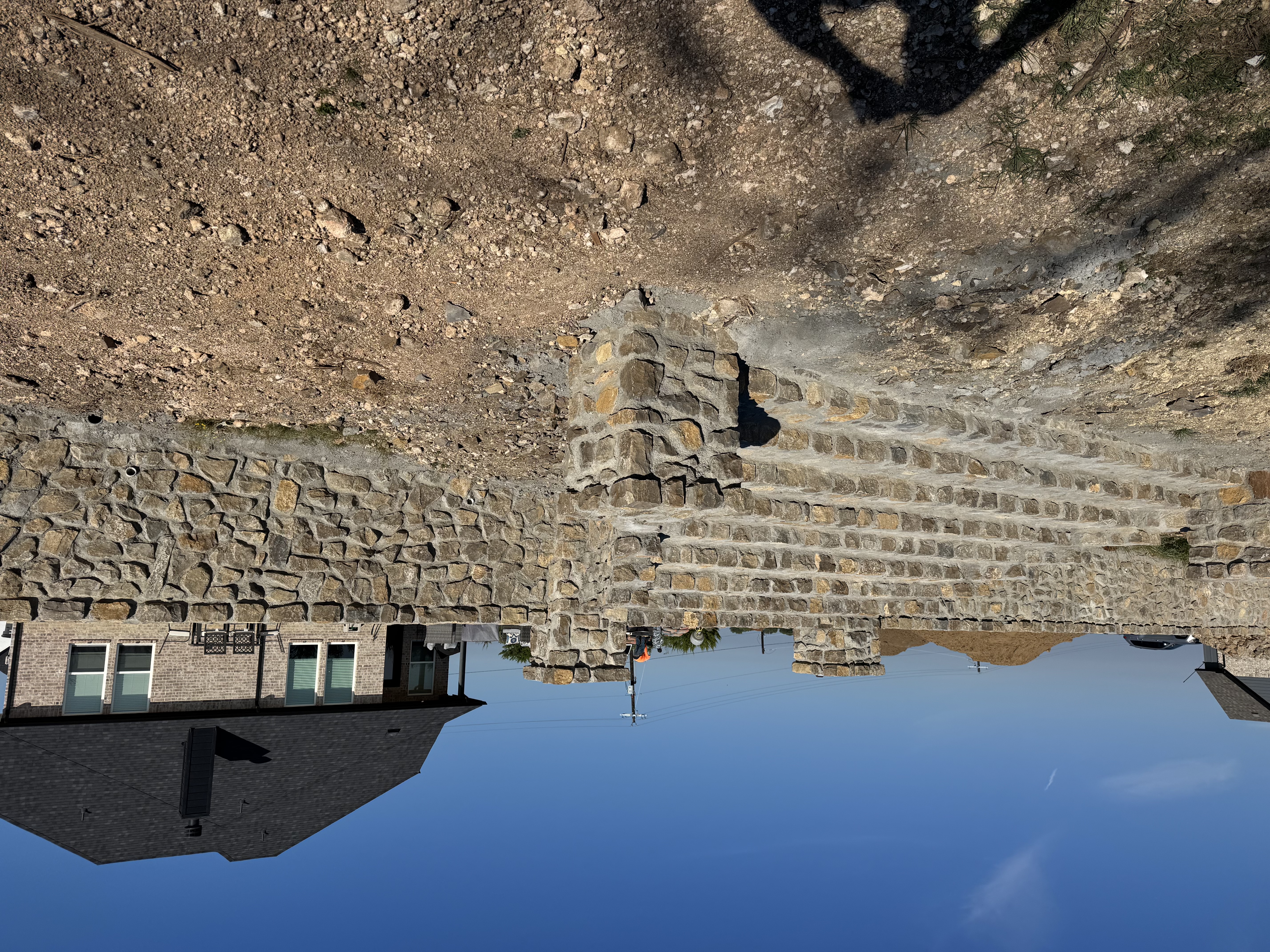 Retaining wall construction on a sloped property in North Texas