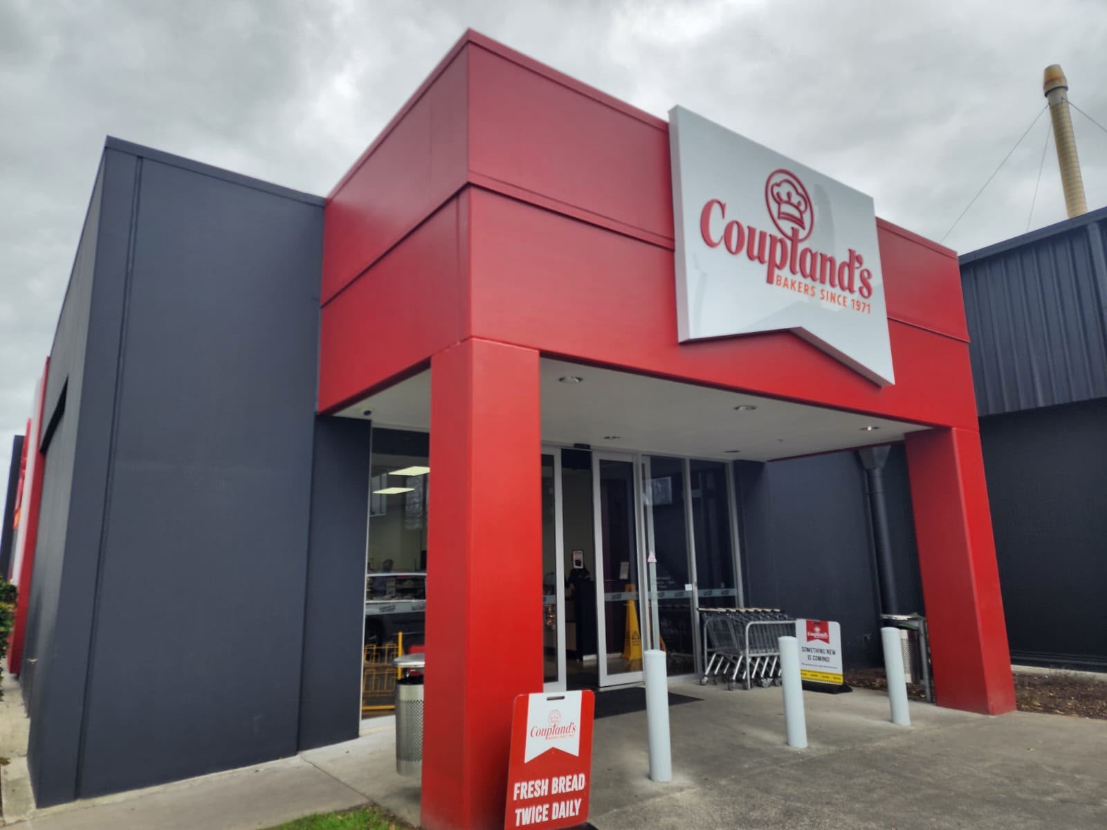 Couplands Bakery exterior facade after repaint with consistent red finish