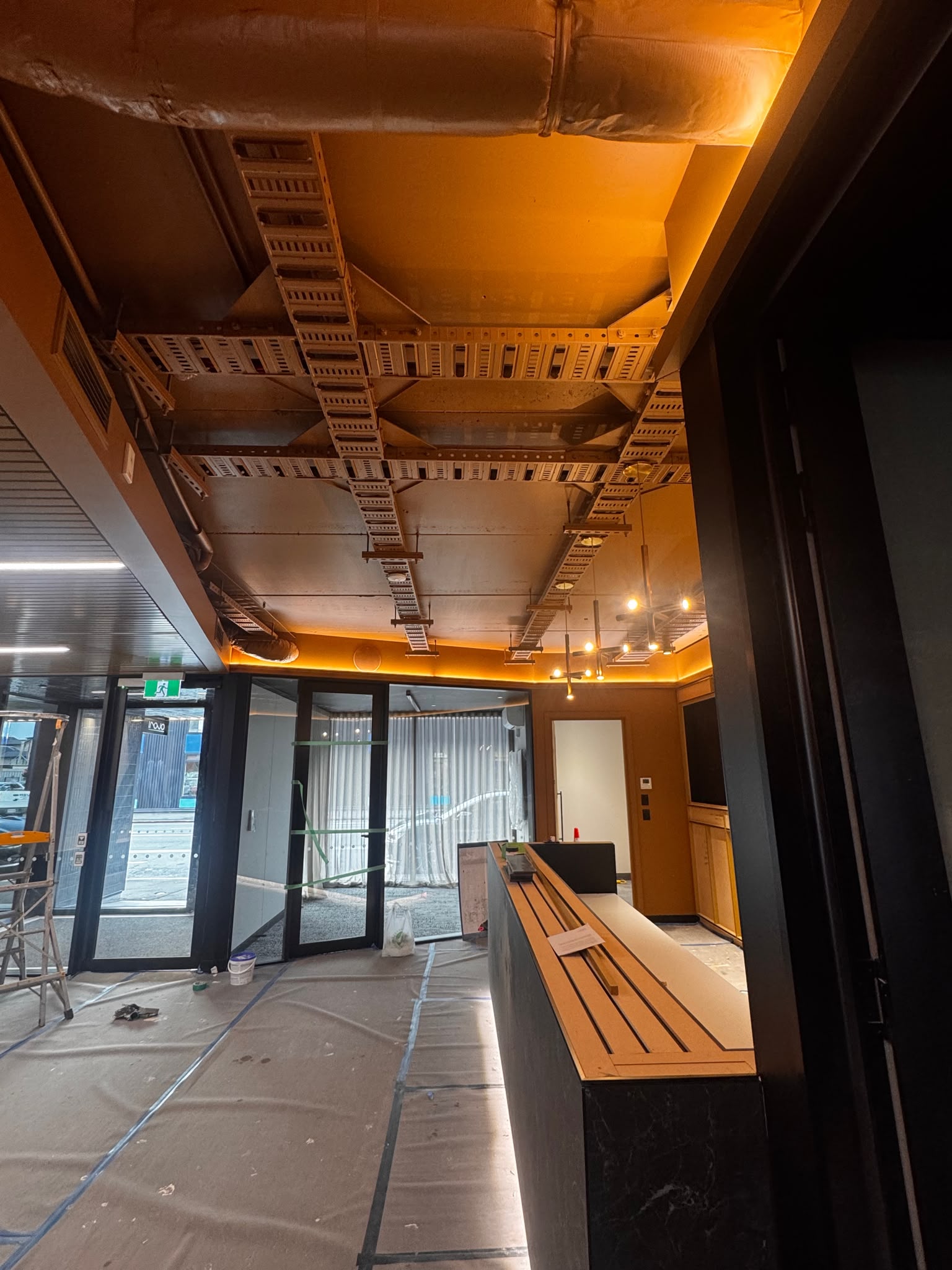Sprayed ceiling and ducting detail in the renovated office