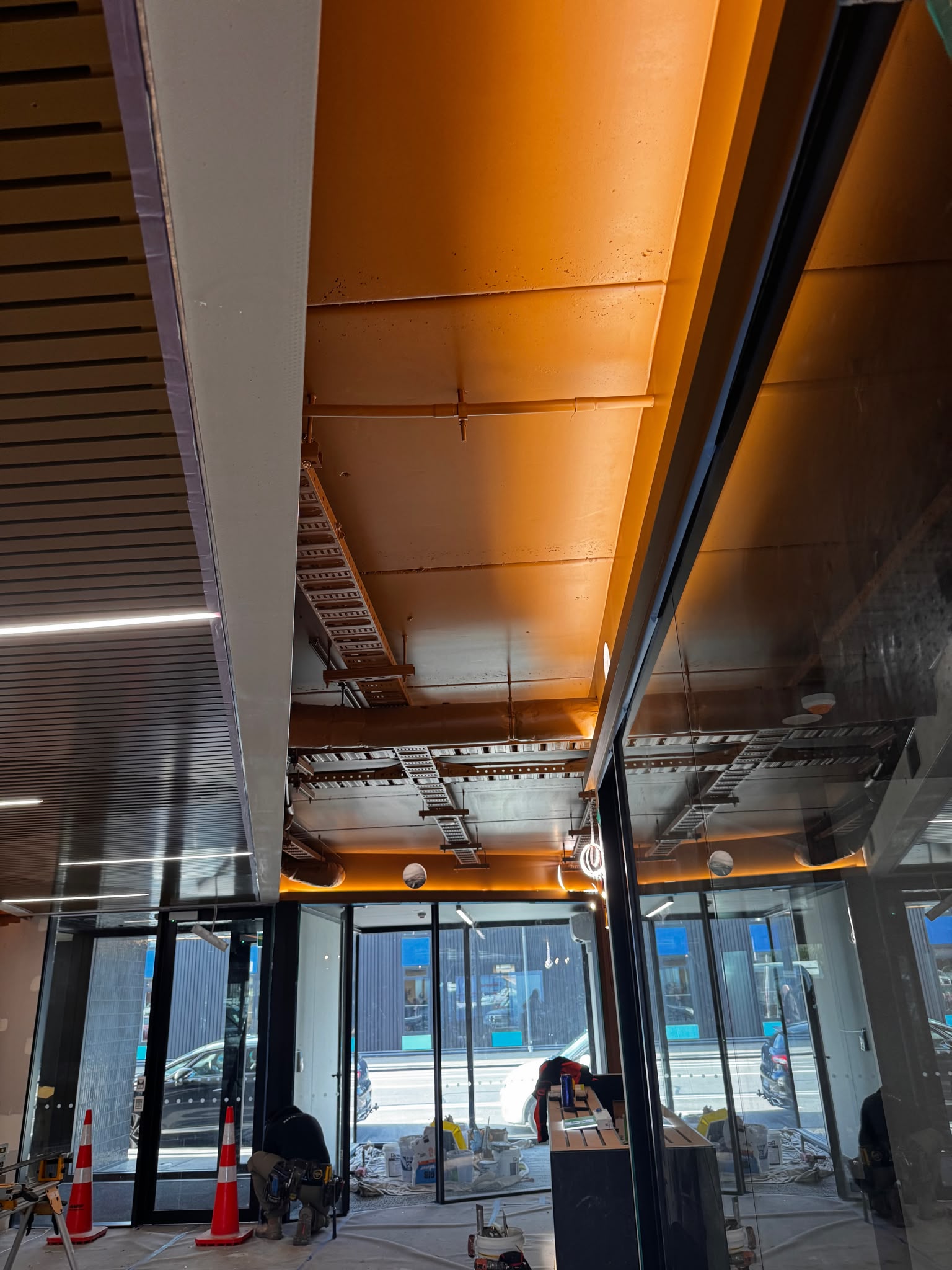 Office interior with spray-finished black ceiling and ducting