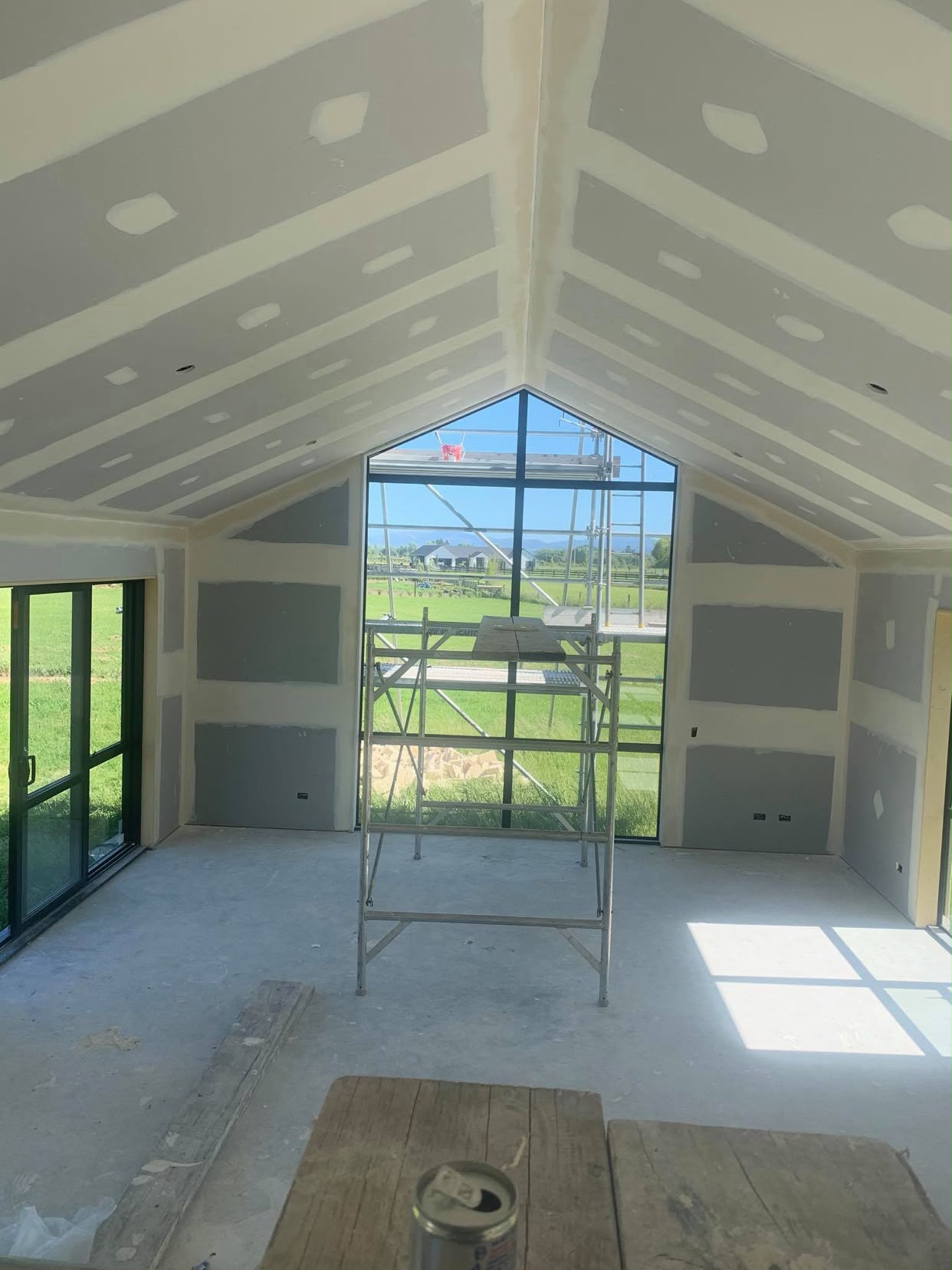 Plastering and stopping preparation across hallway and high ceilings