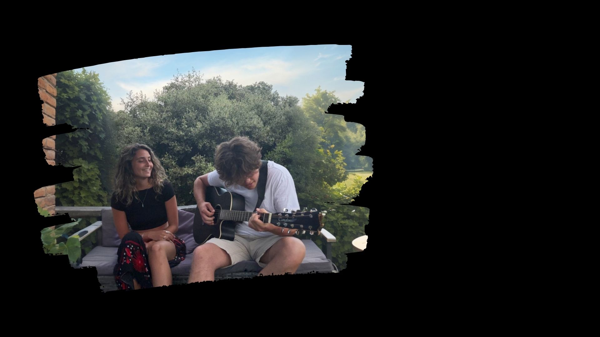 MOMA, the indie folk duo Molly Bobroff and Matthew Day, playing acoustic guitar outdoors