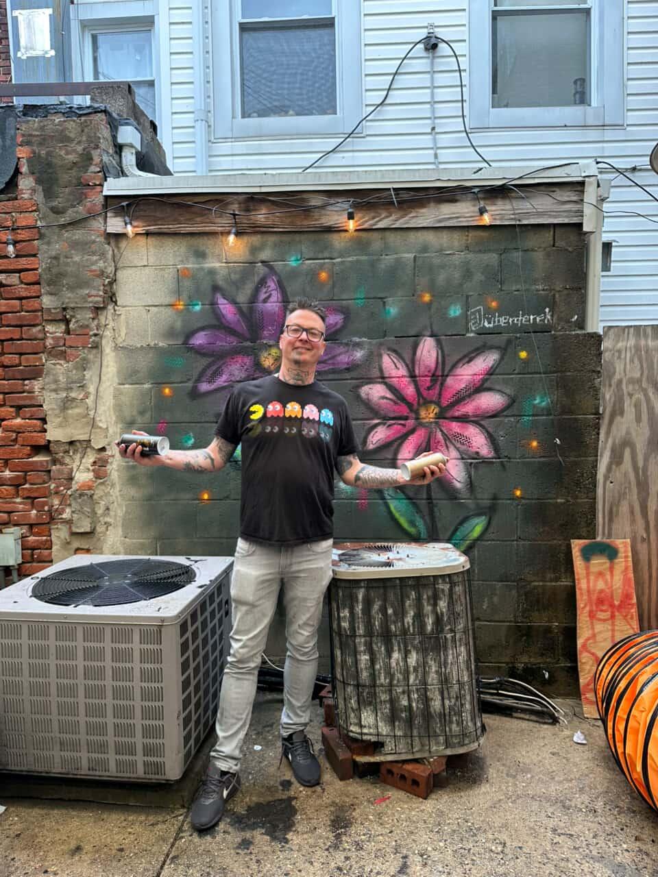 Derek Entenmann, UberDerek, with an original graffiti-style flower painting