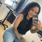 Smallz taking a mirror selfie, tattoos down one arm