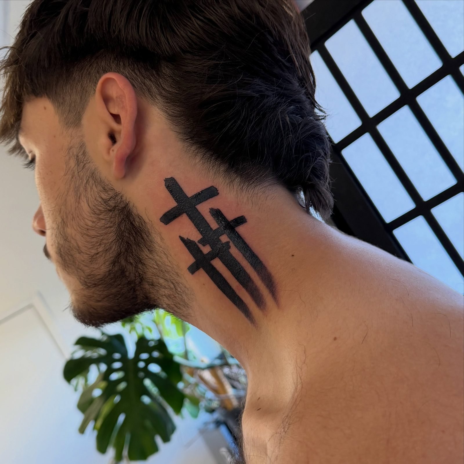 Three bold brushstroke crosses in solid black on the side of the neck, by Miss Champion