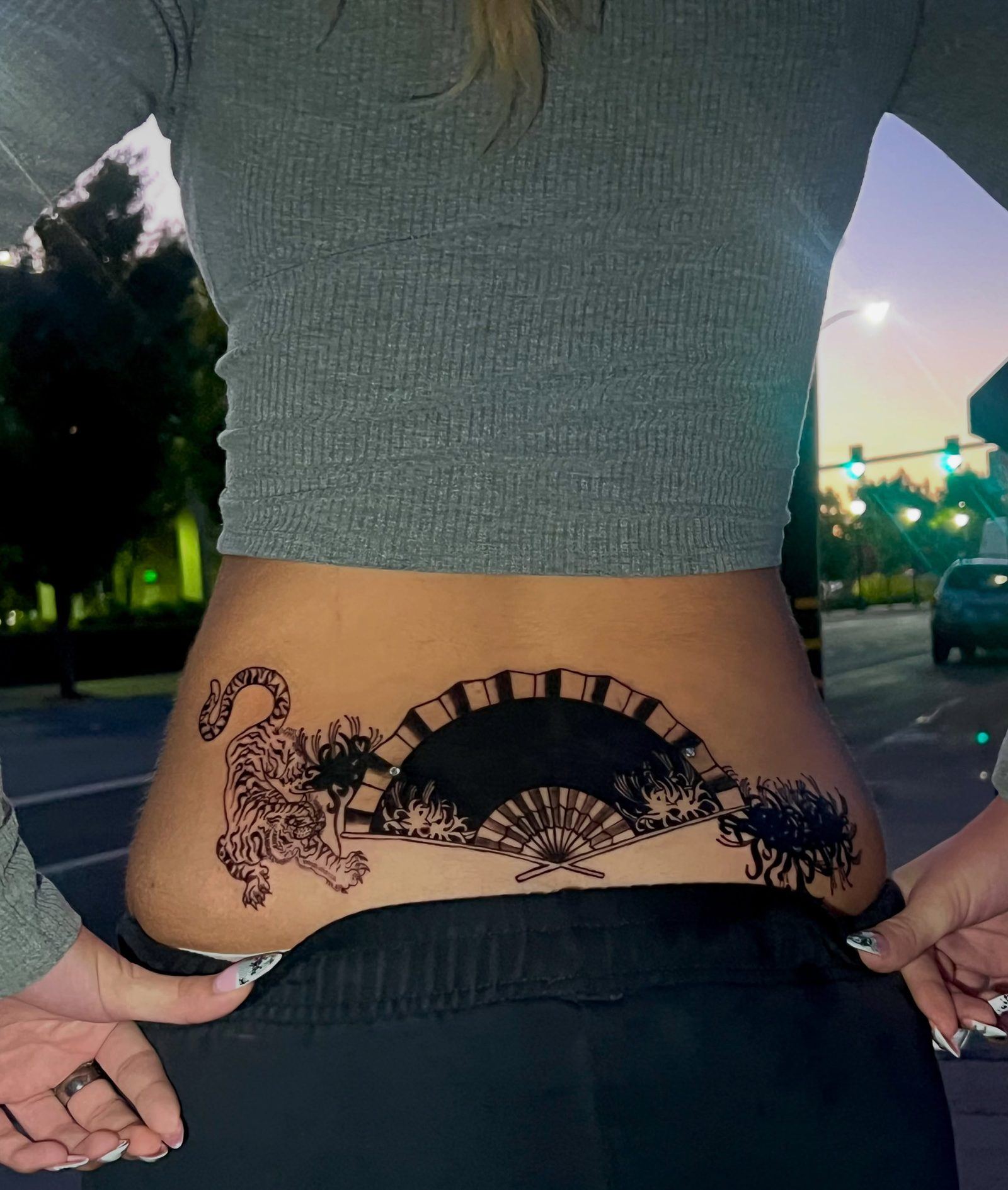 Lower back cover-up by Miss Champion: a black folding fan between a prowling tiger and spider lilies