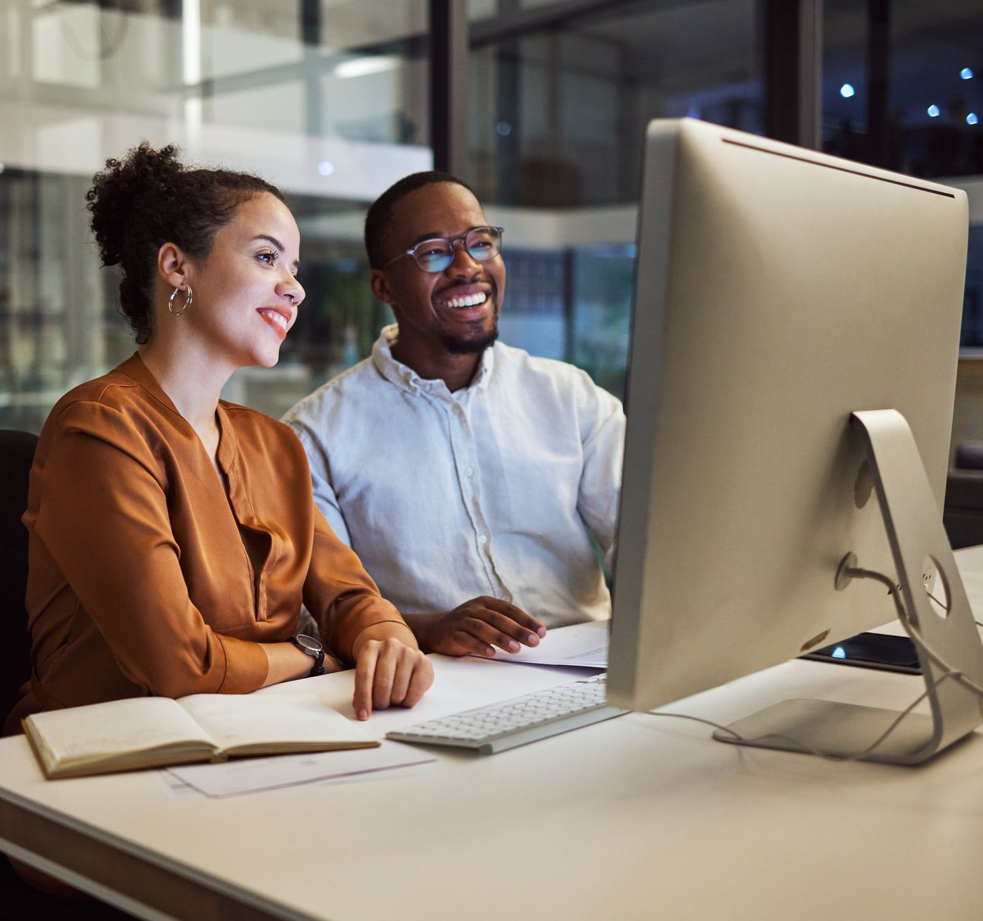 Two business partners working together at a computer