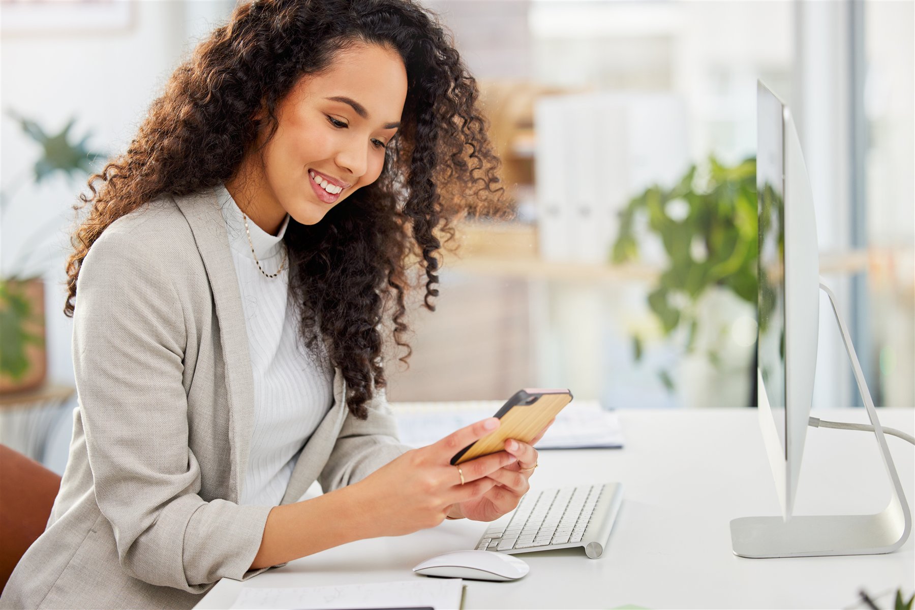 Entrepreneur working on her phone at her desk