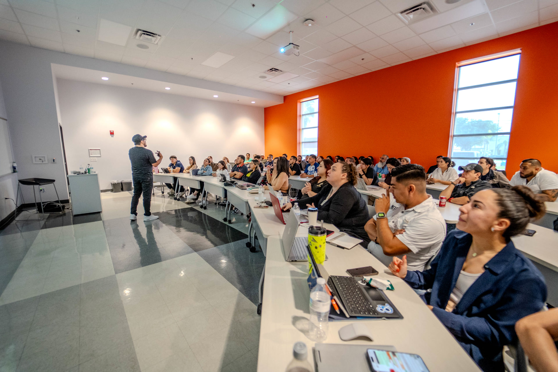 Geno Bernal dando clase frente a un salón lleno