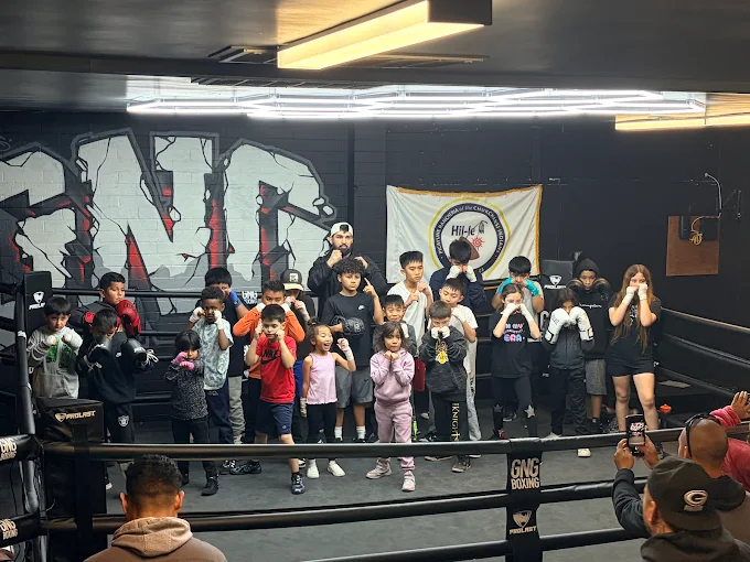 Gloves Not Guns Mission GNG Boxing coach working on mitts with a young fighter