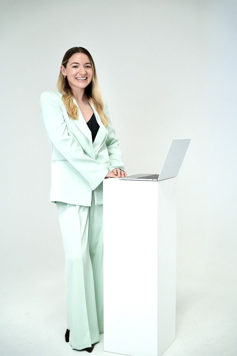 Kara standing with a laptop reviewing local trade performance