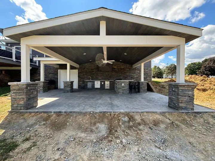Covered outdoor kitchen connected to a finished patio