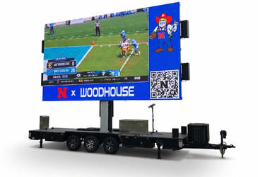 Legion 2313 LED trailer with its 23 x 13 ft screen raised, showing live football and sponsor content