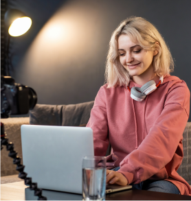 Portrait of blonde woman smiling with laptop