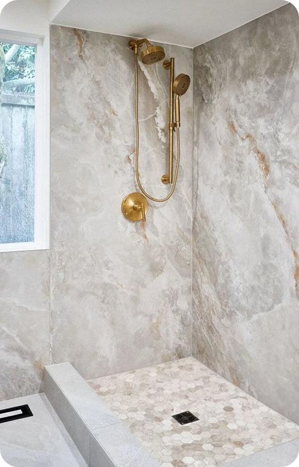 Marble walk-in shower with brass fixtures