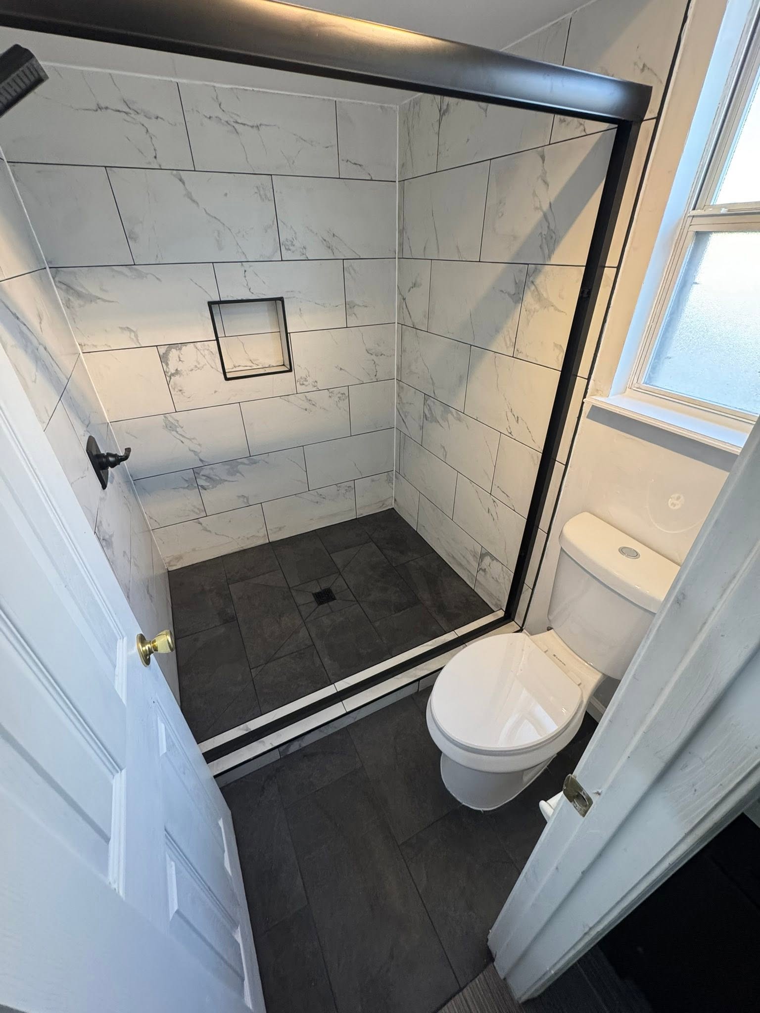 Glass shower with black base, second angle