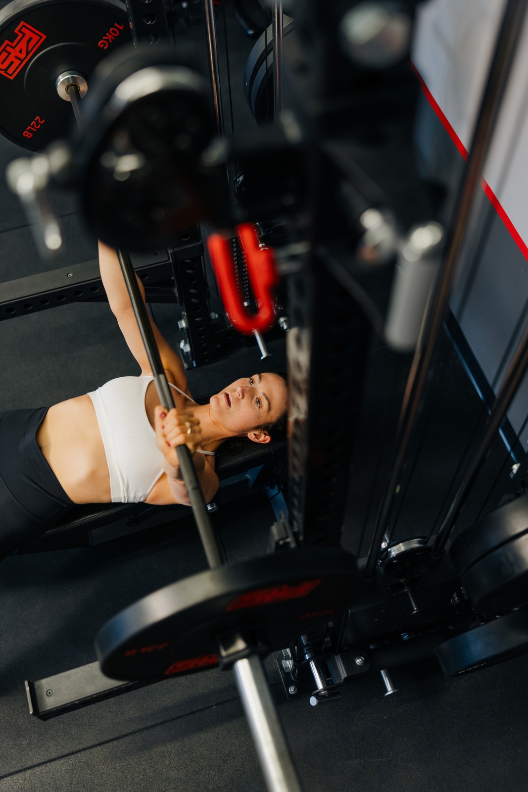 Member bench pressing a barbell during an F45 strength block