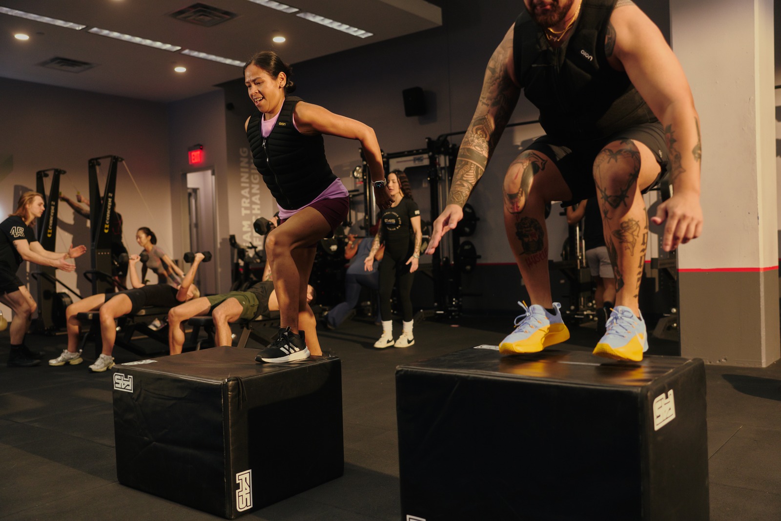 F45 members performing box jumps in a high-energy cardio session