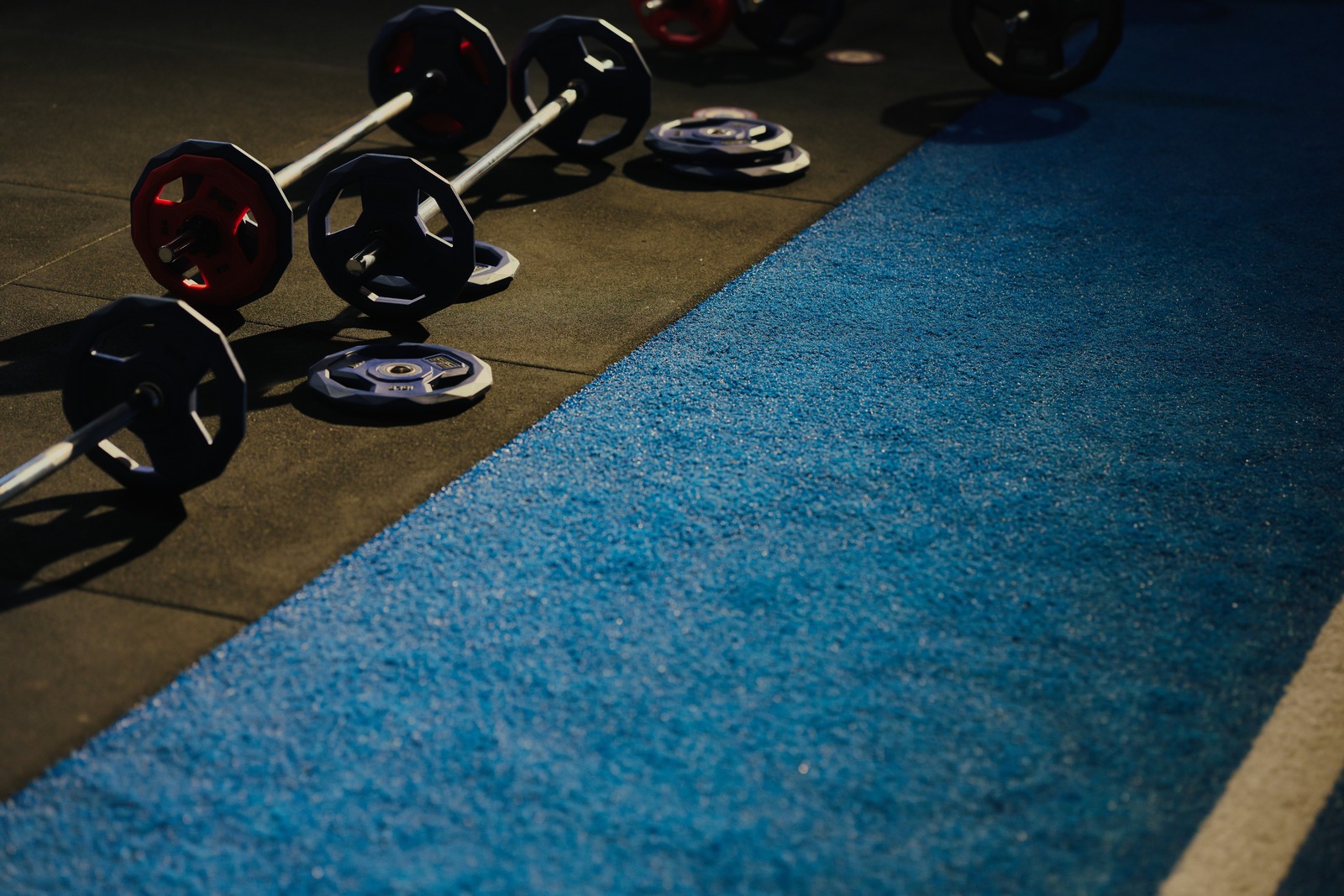 F45 barbells and weight plates on the studio floor