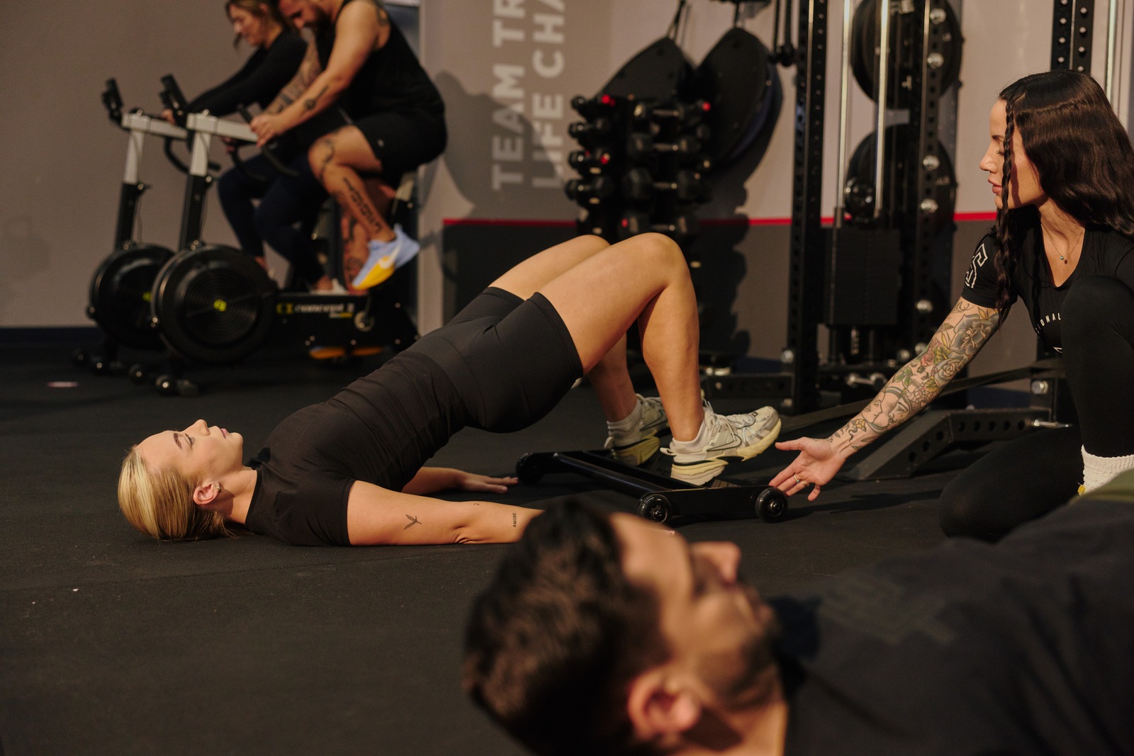 An F45 coach guiding members through a team workout