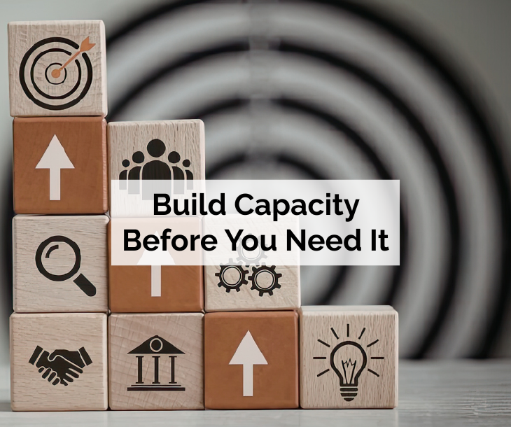Building Capacity Before You Need It - building blocks with business growth icons in front of a target