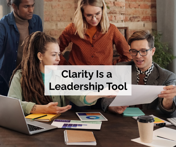Clarity Is a Leadership Tool - business team discussing data while looking at printouts on table Clarity Is a Leadership Tool - business team discussing data while looking at printouts on table