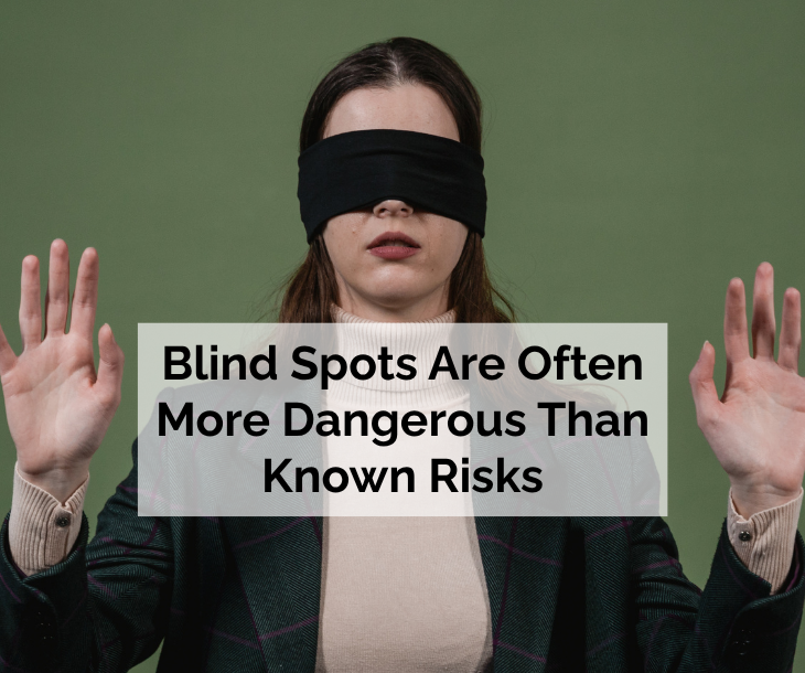 Blindfolded businesswoman representing financial blind spots and business risk