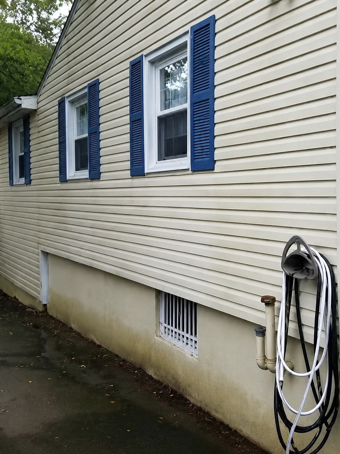 Exterior surface before professional cleaning by Thin Red Line Pressure Washing in Clifton Park, NY.