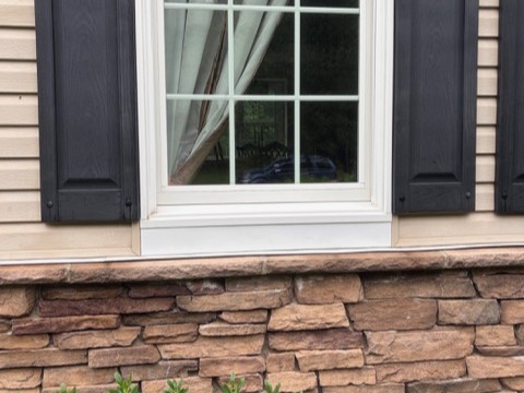 Stone veneer and window exterior after professional cleaning by Thin Red Line Pressure Washing in Clifton Park, NY.