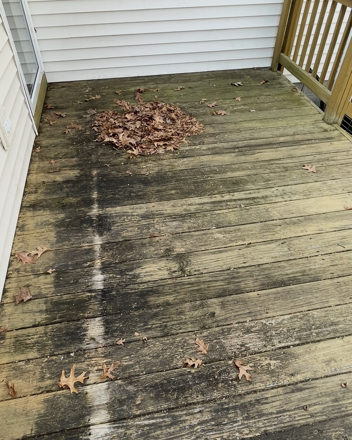 Wood deck with dirt, algae, and organic buildup before professional cleaning by Thin Red Line Pressure Washing in Clifton Park, NY.